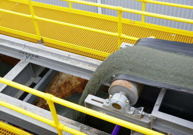 Intake system with hoppers, shuttle belt conveyor, FRP walkways, and platforms supplied by CIL Ltd for new masonry block plant in New Zealand.