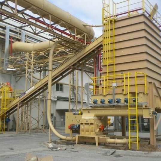Live bottom bin and metered feed system with air-supported belt conveyor and collector screw designed by CIL Ltd for particleboard plant in Vietnam.