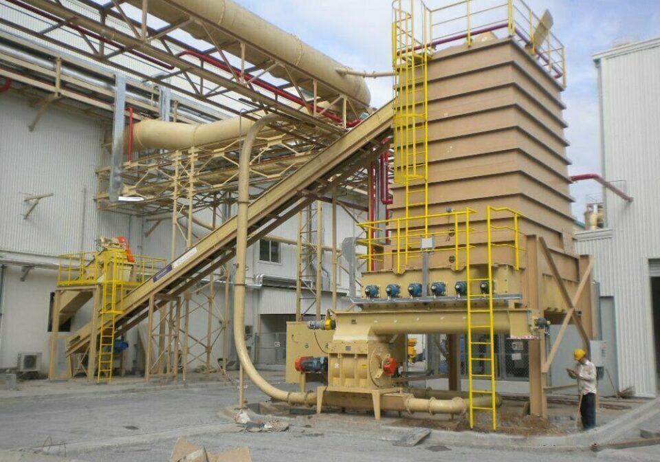 Live bottom bin and metered feed system with air-supported belt conveyor and collector screw designed by CIL Ltd for particleboard plant in Vietnam.