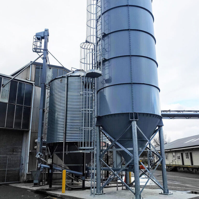Silo storage and screw conveyor discharge system designed and installed by CIL Ltd for wood pellet fuel supply to a community boiler in New Zealand.
